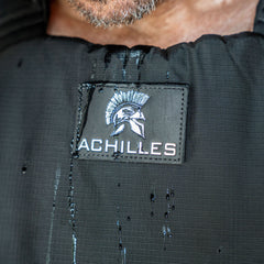 Close-up of the Achilles | Men's Weighted Vest featuring a Spartan helmet logo and water droplets on its premium exterior.