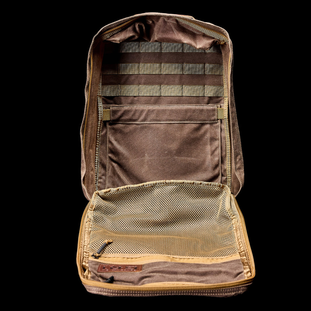 An open brown tactical pouch with mesh pocket and MOLLE webbing, styled to complement the GORUCK GR1 USA - Heritage rucksack, displayed against a black background.