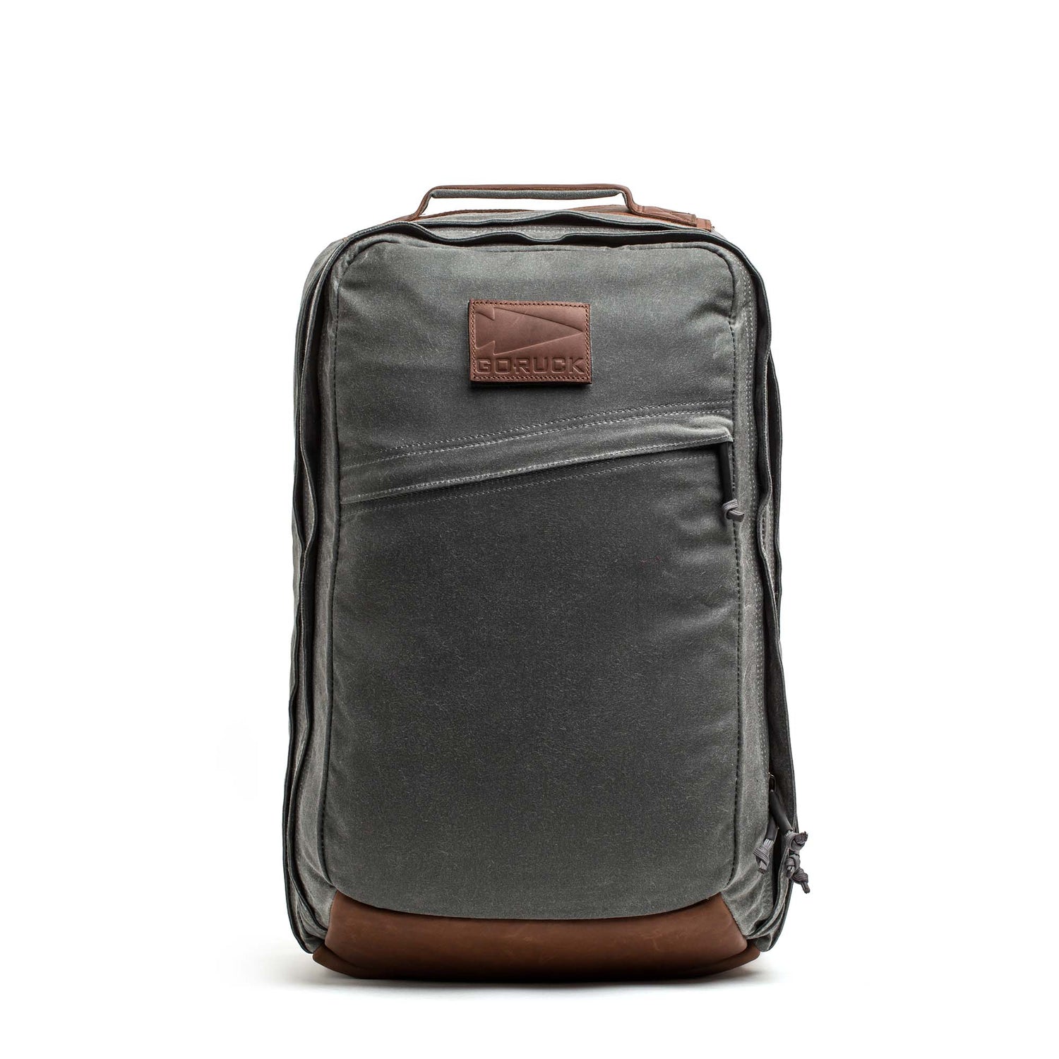 The GORUCK GR2 - Heritage Waxed Canvas backpack features gray waxed canvas, brown Red Wing leather accents, a front zipper pocket, and a convenient top handle—an upright, stylish ruck perfect for travel.