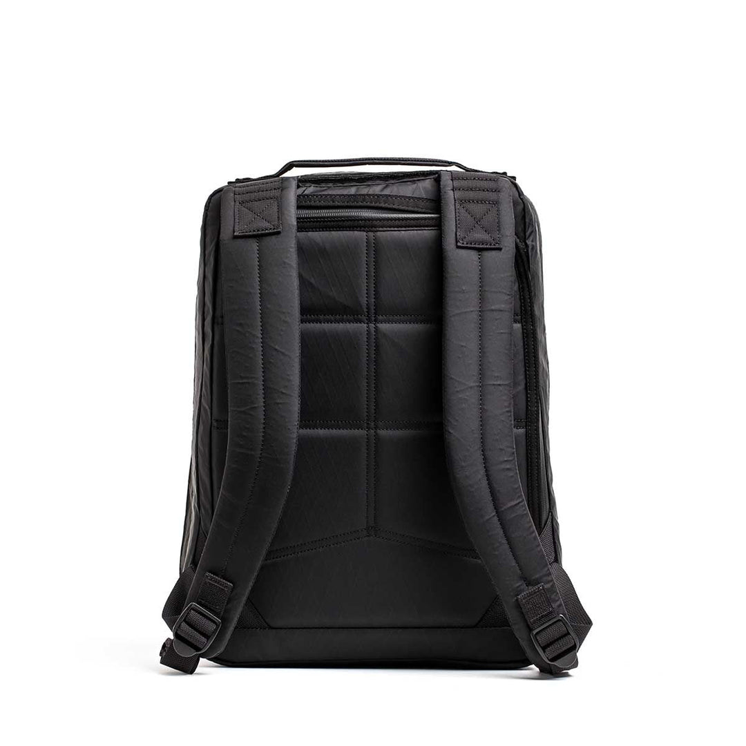 The GORUCK GR0 - X-PAC backpack shown from the back features padded shoulder straps and a textured, lightweight X-PAC back panel.