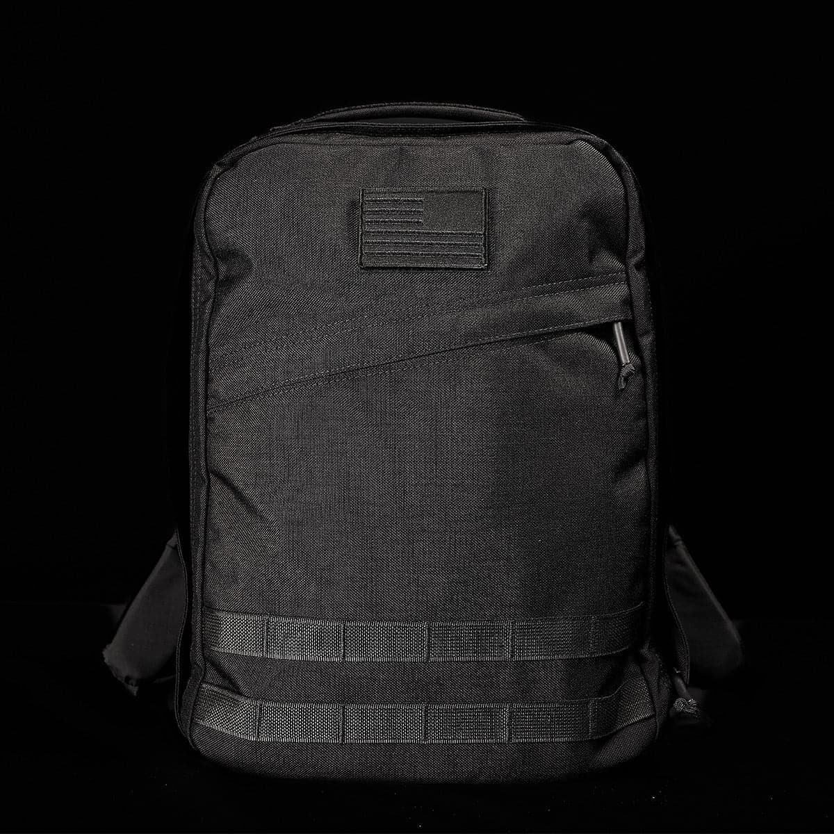 GORUCK black rucksack with American flag patch, durable tactical backpack on black background
