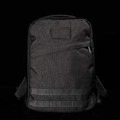 GORUCK black rucksack with American flag patch, durable tactical backpack on black background