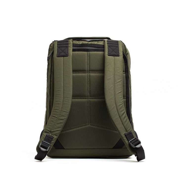Back view of the GORUCK GR0 - X-PAC in olive green, featuring lightweight construction, padded straps, and quilted detailing against a white background.