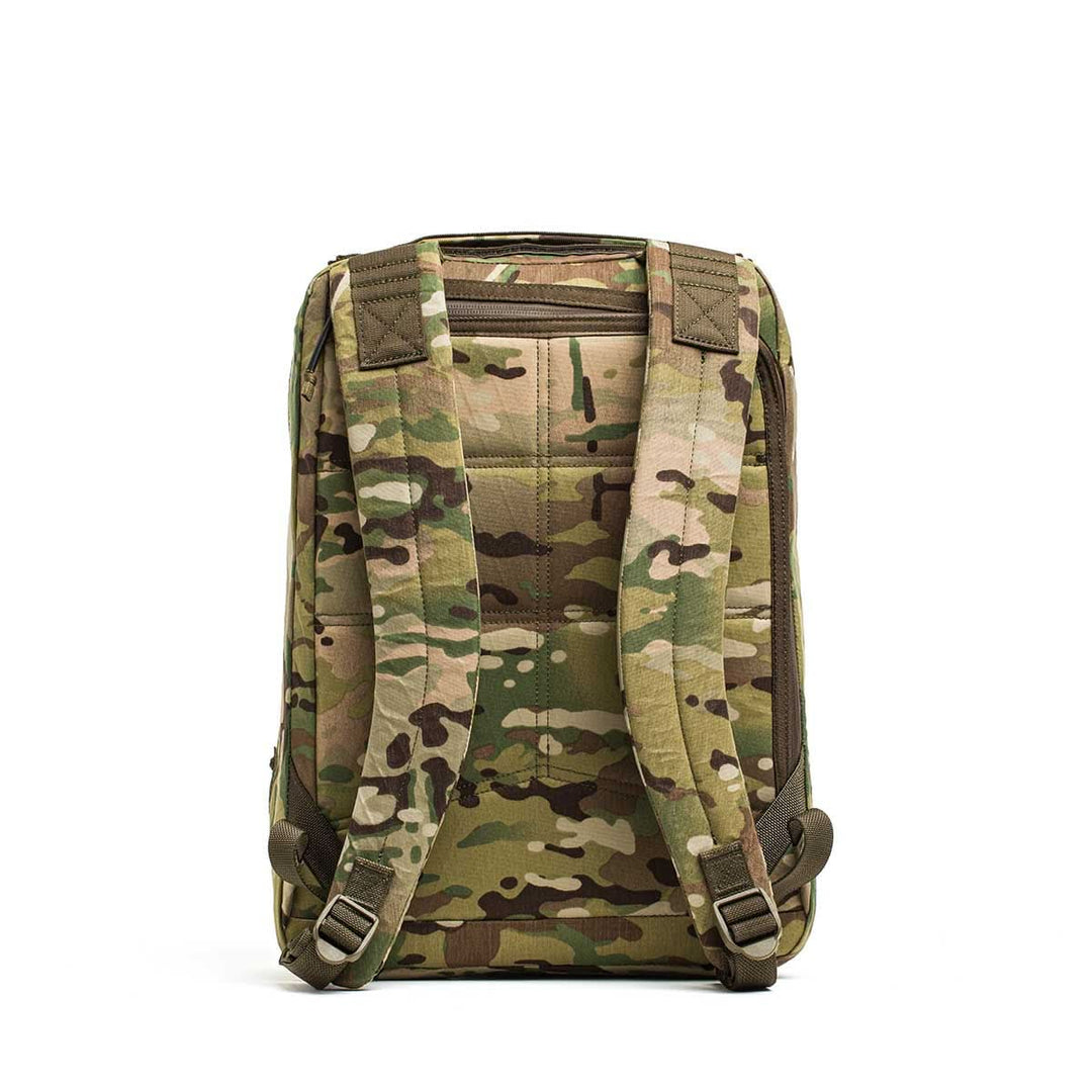 Back view of the GORUCK GR0 - X-PAC, a lightweight backpack with a camouflage pattern and padded shoulder straps, made from durable X-PAC material, shown against a white background.