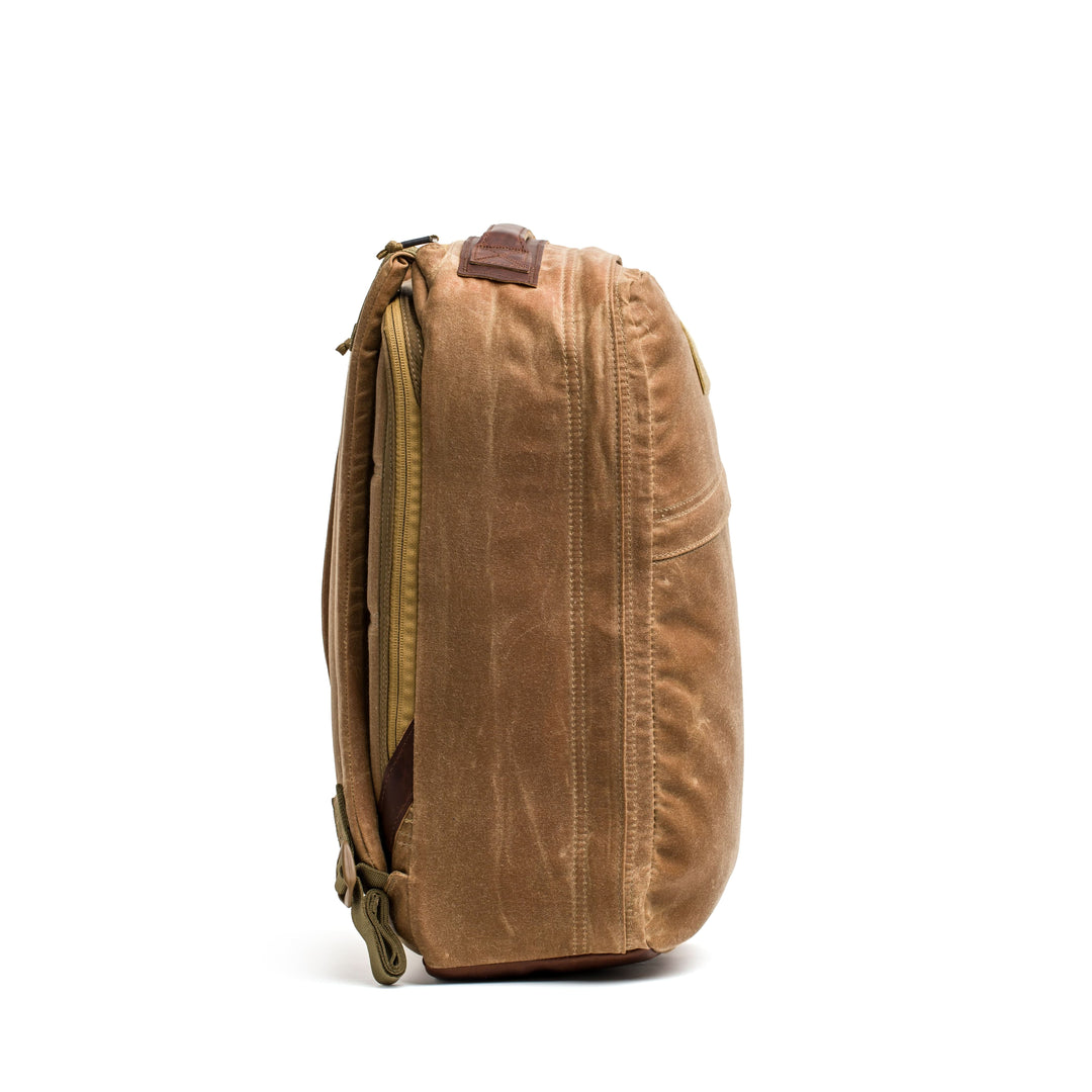The light brown GR1 USA - Heritage backpack from GORUCK features a waxed duck canvas, zippers, and a leather accent, reminiscent of a classic retro rucksack.