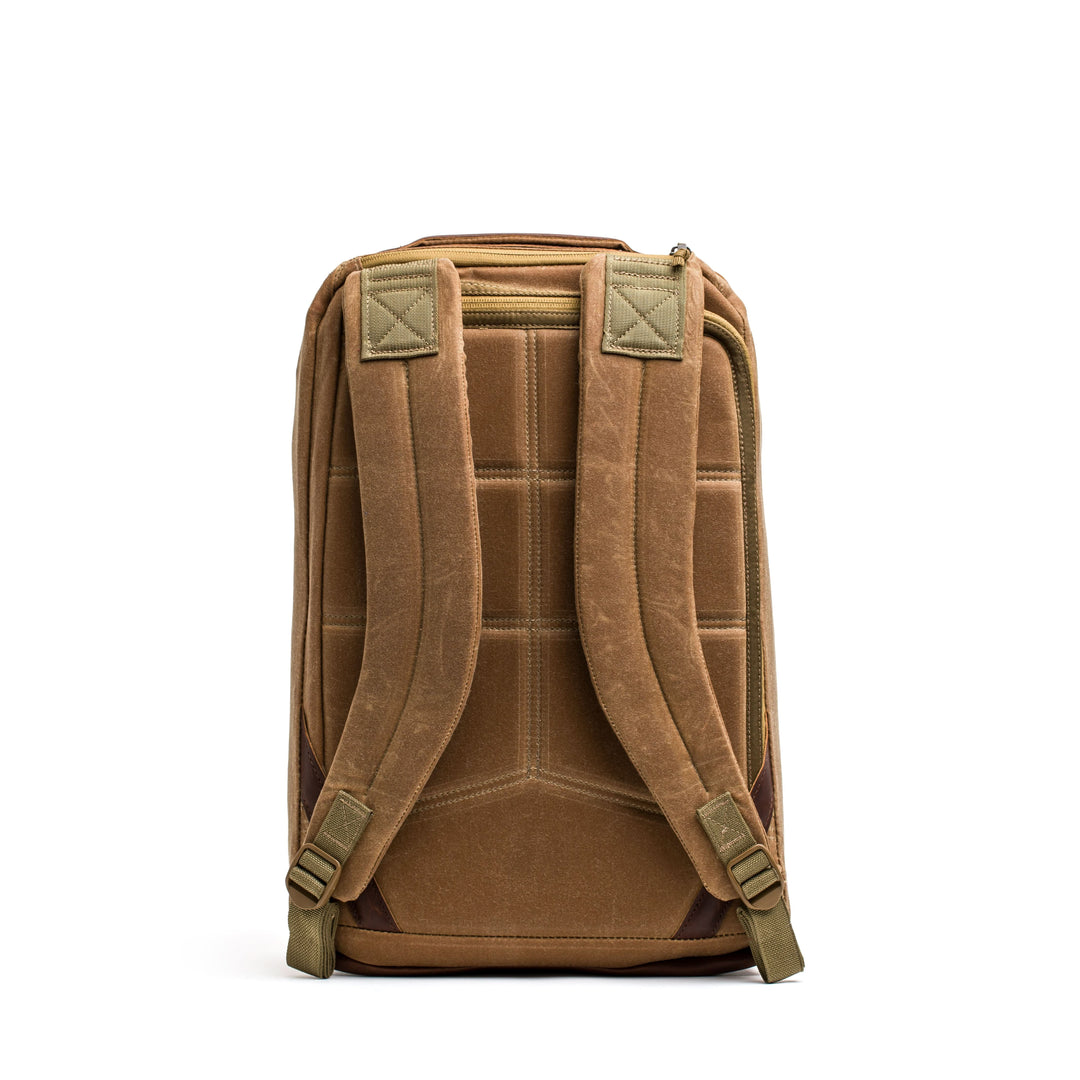 The brown GORUCK GR1 USA - Heritage rucksack, featuring padded straps and a quilted back panel, is shown from the rear on a white background.