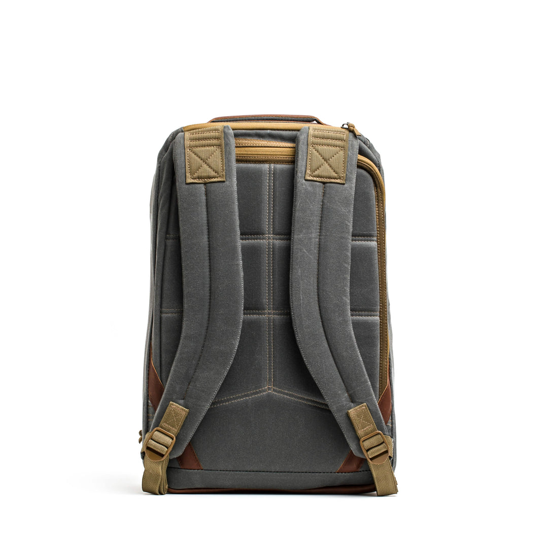 The GR1 USA - Heritage backpack by GORUCK features padded straps and brown accents, evoking a retro canvas rucksack, as seen from the back against a white background.