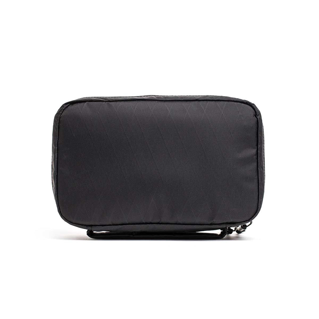 The GORUCK GR1 Field Pocket - X-PAC is a black rectangular electronics organizer with AquaGuard zippers, a small handle, and waterproof fabric, shown against a white background.