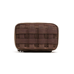 The GR1 Field Pocket is a small brown tactical pouch with front webbing, ideal for organizing electronics or attaching to gear and bags.