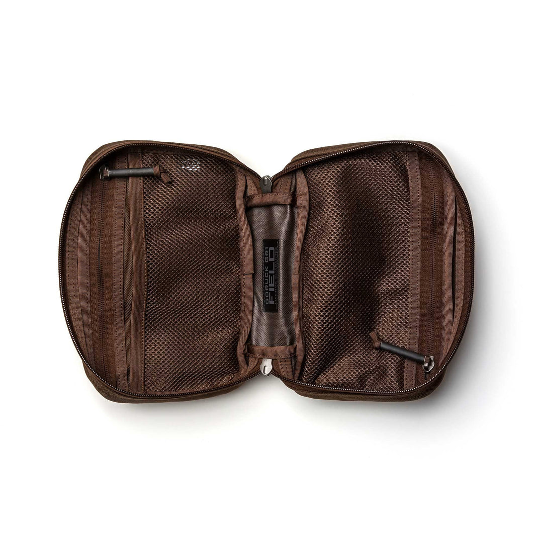 The GR1 Field Pocket, shown unzipped on a white background, reveals mesh and fabric compartments ideal for organizing electronics or keeping camera gear tidy.