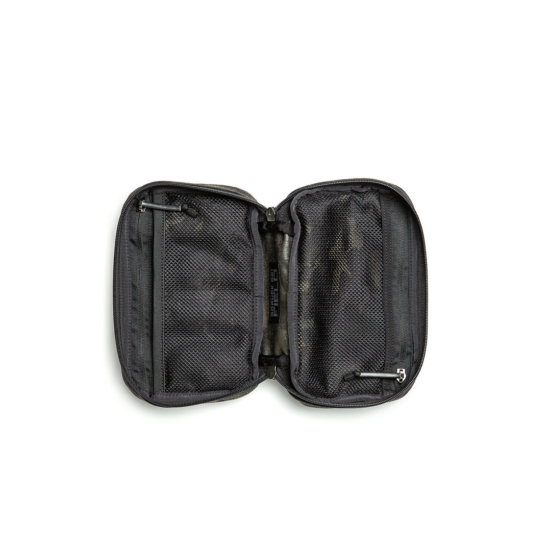 The GORUCK GR1 Field Pocket, an open black zippered pouch with mesh pockets and compartments for organizing camera gear, is displayed on a white background.