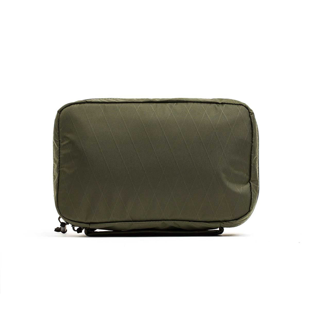 The GORUCK GR1 Field Pocket - X-PAC is an olive green rectangular pouch with a quilted pattern, made from waterproof fabric and equipped with AquaGuard zippers—perfect for organizing electronics. Shown on a white background.