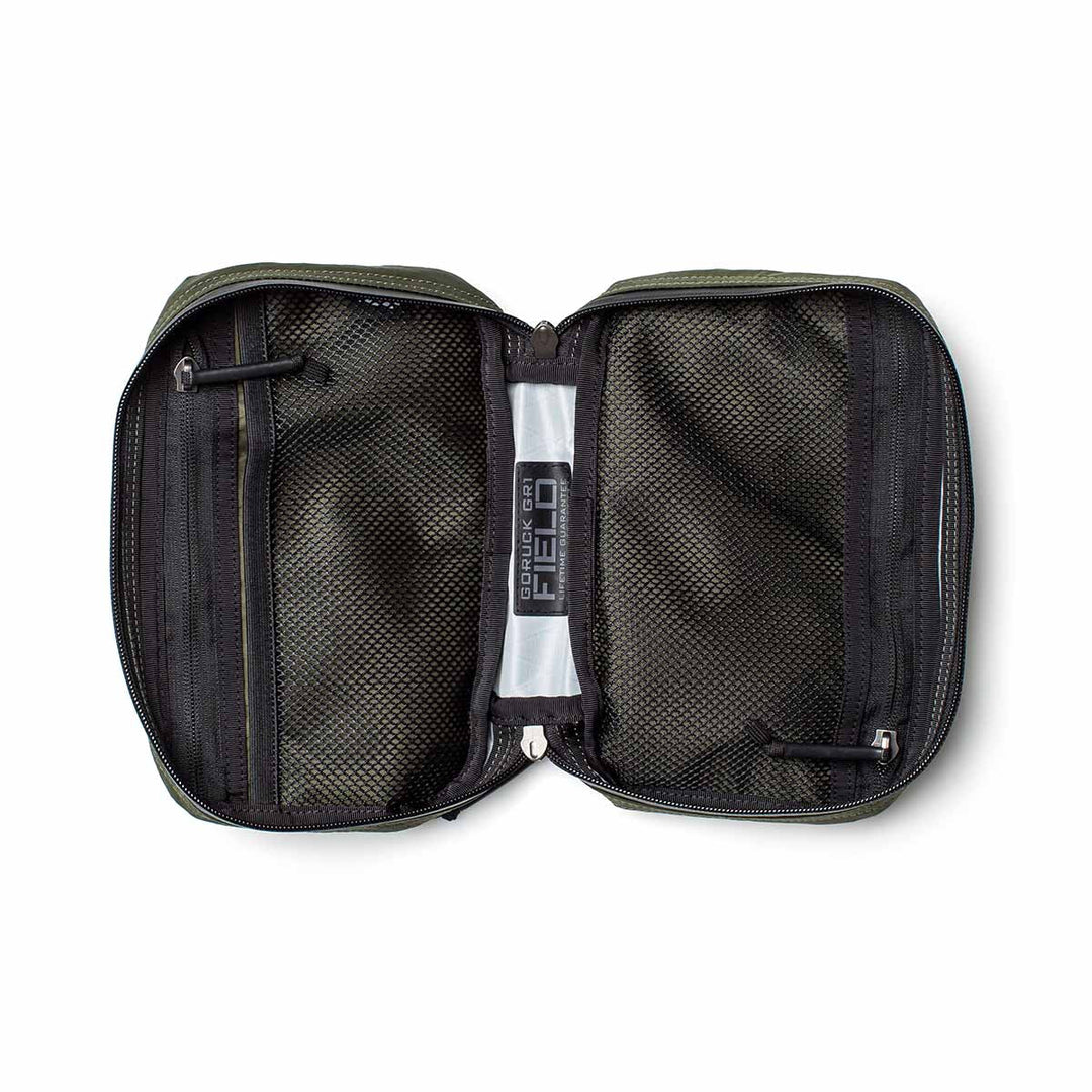The GORUCK GR1 Field Pocket - X-PAC is a black mesh electronics organizer with zippered compartments, a clear plastic center divider, and durable AquaGuard zippers to securely store your essentials.
