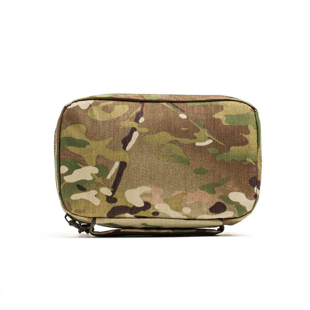 The GORUCK GR1 Field Pocket - X-PAC is a rectangular electronics organizer pouch with a green and brown camouflage pattern, crafted from waterproof fabric and shown against a white background.