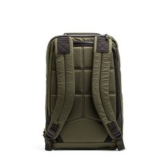 The GR1 USA - X-PAC by GORUCK is a green backpack with a padded back, adjustable shoulder straps, and AquaGuard zippers for enhanced durability, displayed from the rear.
