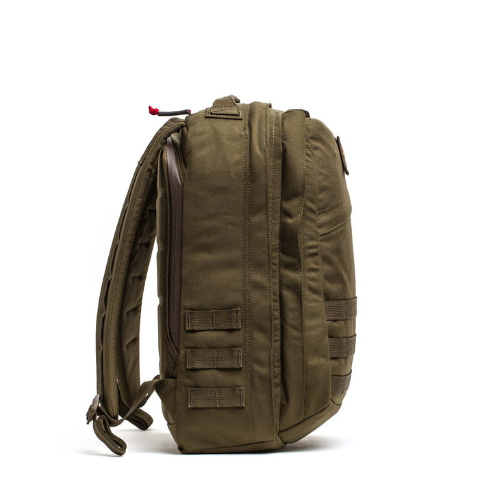 The GORUCK GR2 olive green tactical backpack, shown side view on white background, features padded straps, side loops, and rugged durability. Inspired by the GR2 ruck, it's built for adventure with a functional travel-ready design.