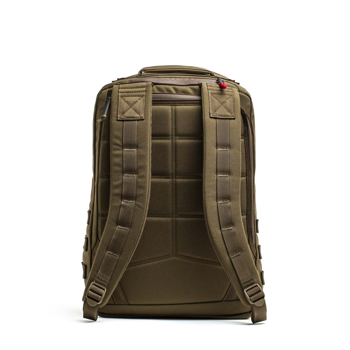 The GORUCK GR2 is a brown travel backpack shown from the back, featuring padded shoulder straps and a quilted back panel for comfort and durability, inspired by Special Forces rucksacks.
