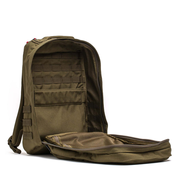 A khaki GORUCK GR2 ruck with its main compartment open shows internal pockets and mesh organizers—ideal as a Special Forces backpack or versatile carry-on travel bag.