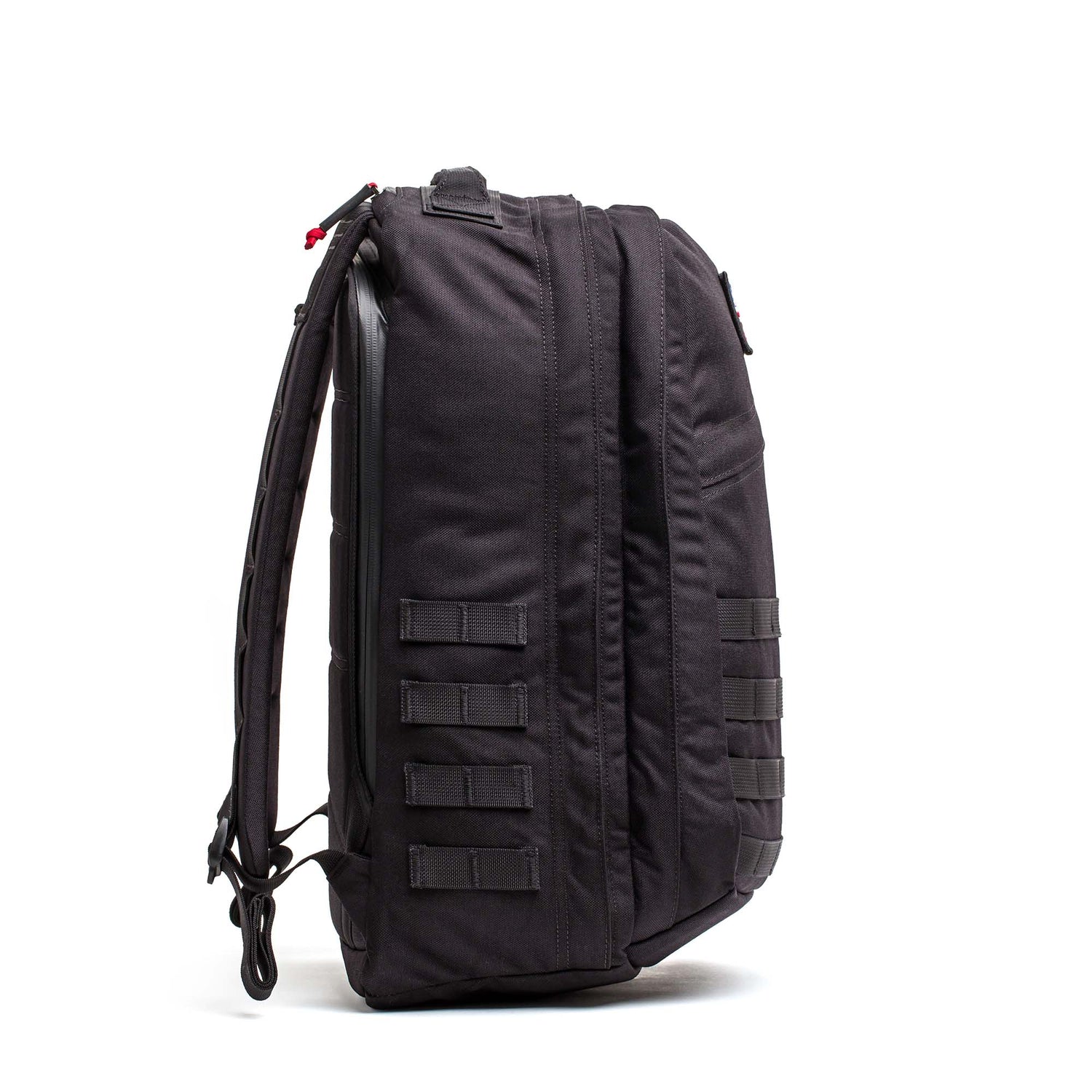 The GORUCK GR2 backpack, shown from the side, features multiple horizontal straps and padded shoulder straps—making it a durable carry-on option for any adventure.
