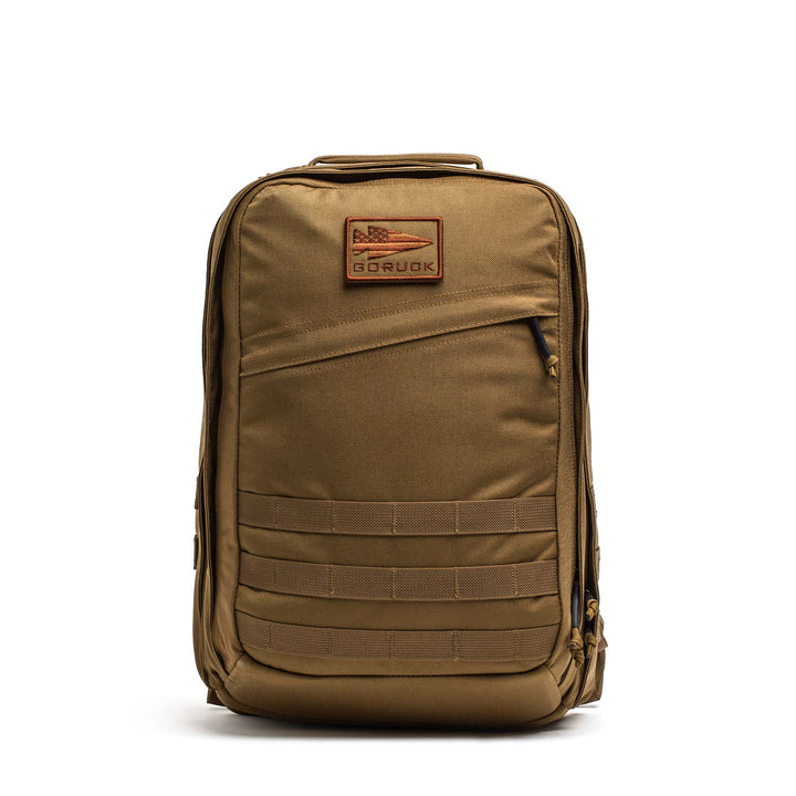 The GORUCK GR2 is a tan tactical travel backpack with multiple compartments, a front patch, and lower front MOLLE webbing—perfect for those who want Special Forces rucksack style and rugged functionality.