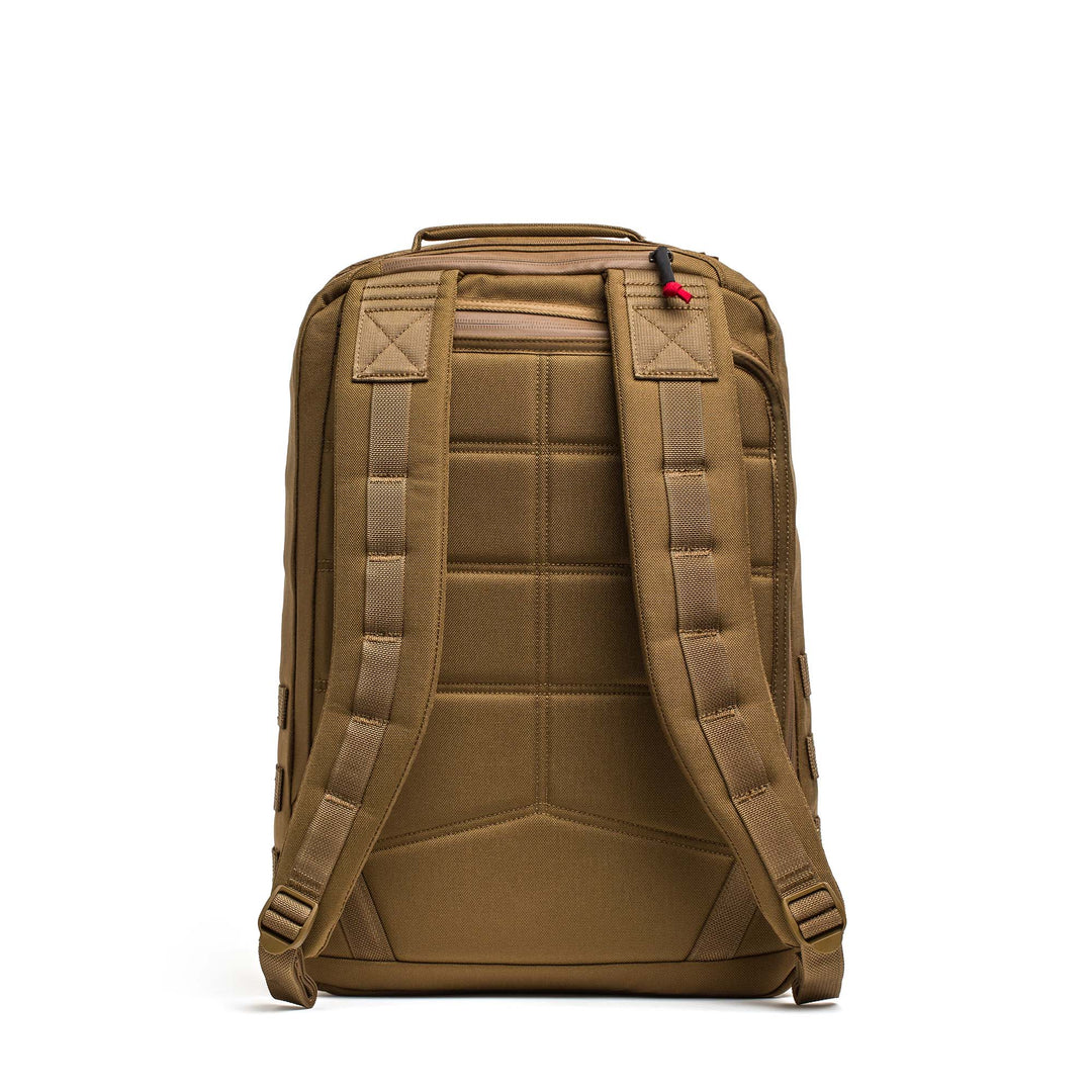 A brown GORUCK GR2 travel backpack shown from the back, featuring padded shoulder straps and a top handle—resembling the classic ruck used by Special Forces.
