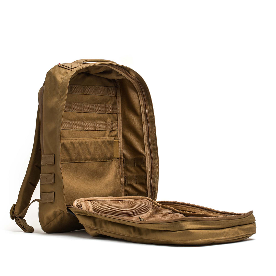 The GORUCK GR2 travel rucksack in brown features a spacious main compartment with inside pockets and a mesh organizer—ideal for keeping essentials organized on any journey.