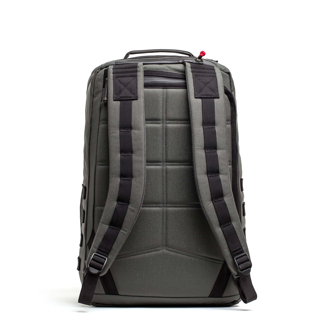 The GORUCK GR2 is a gray carry-on backpack, shown from the back, featuring padded shoulder straps and a top handle.