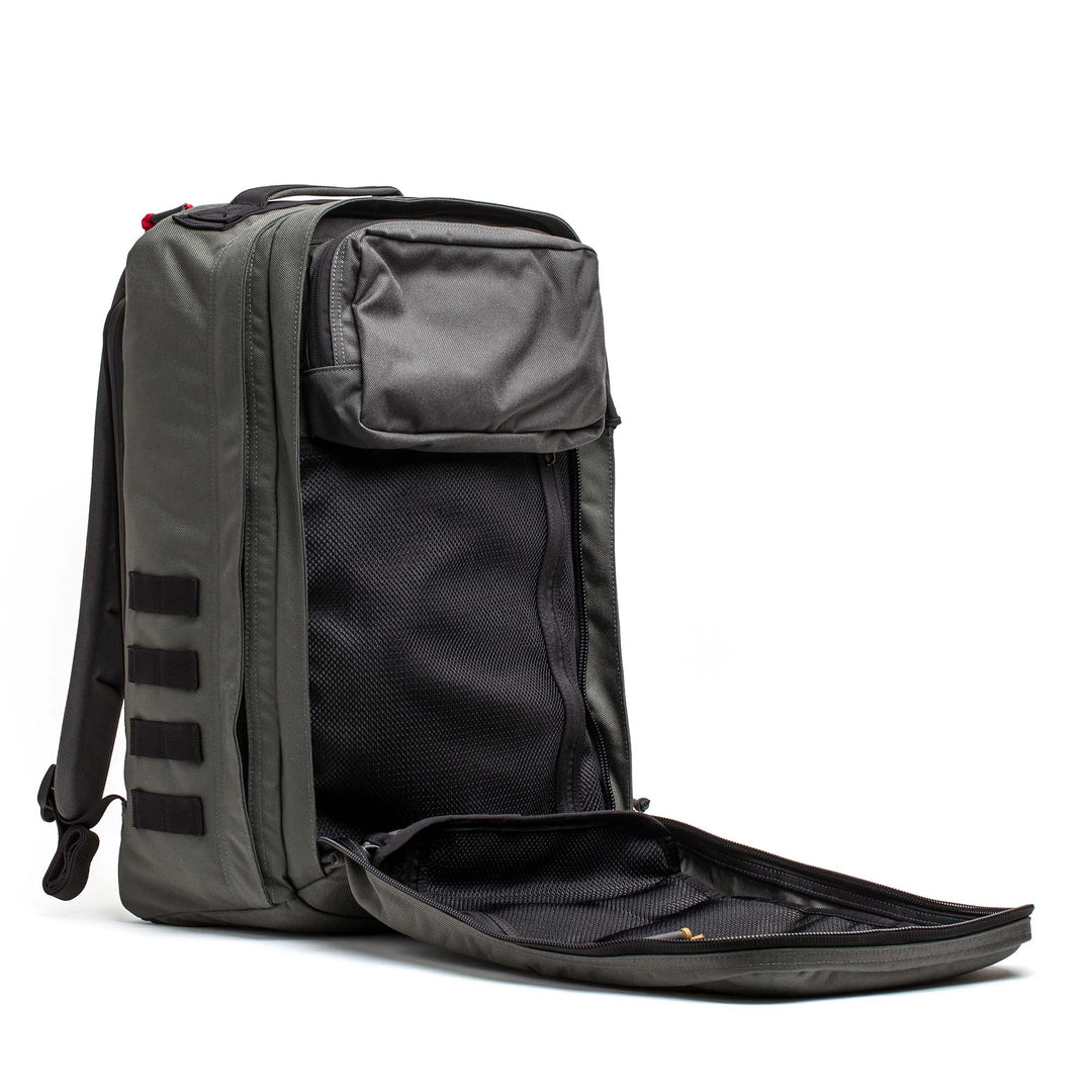 The GORUCK GR2 is a gray carry-on backpack shown with its main compartment unzipped, revealing interior pockets and mesh lining.