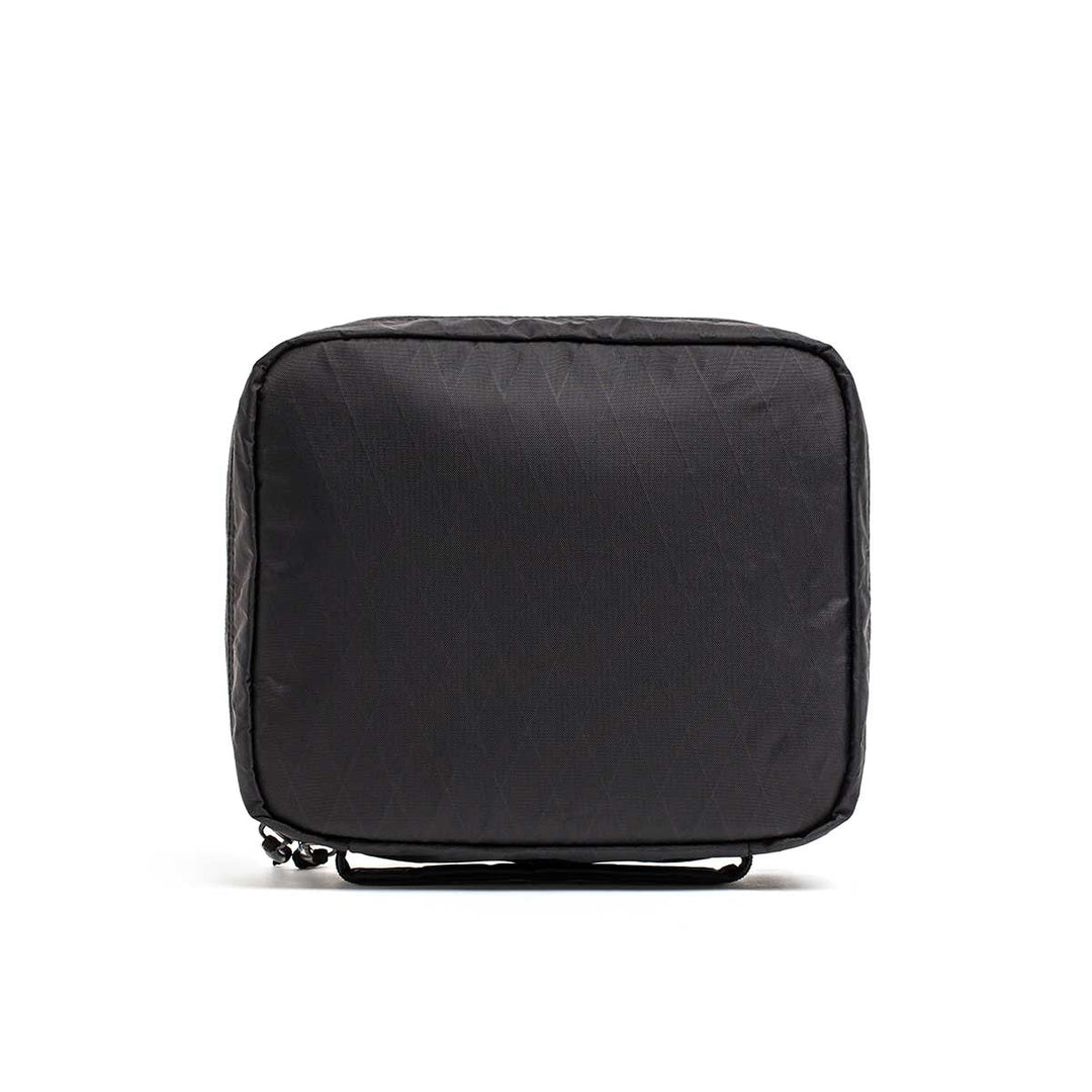 The GORUCK GR2 Field Pocket - X-PAC is a black, square soft case with a zipper, made from waterproof fabric—perfect as an electronics organizer—displayed on a white background.