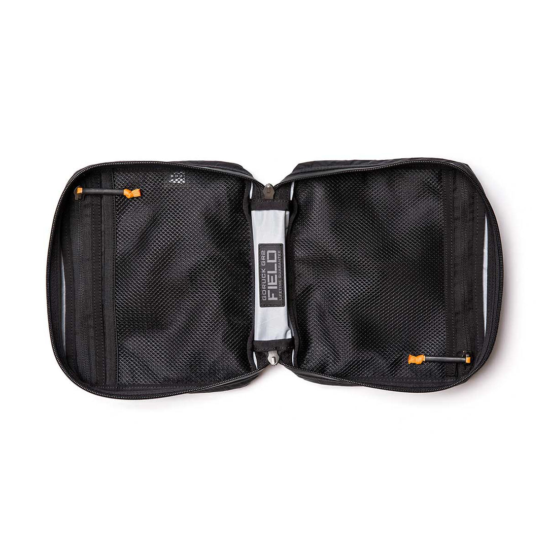 The GORUCK GR2 Field Pocket - X-PAC unzips flat to reveal mesh pockets and orange zipper pulls inside—ideal as an electronics organizer or for carrying camera gear.