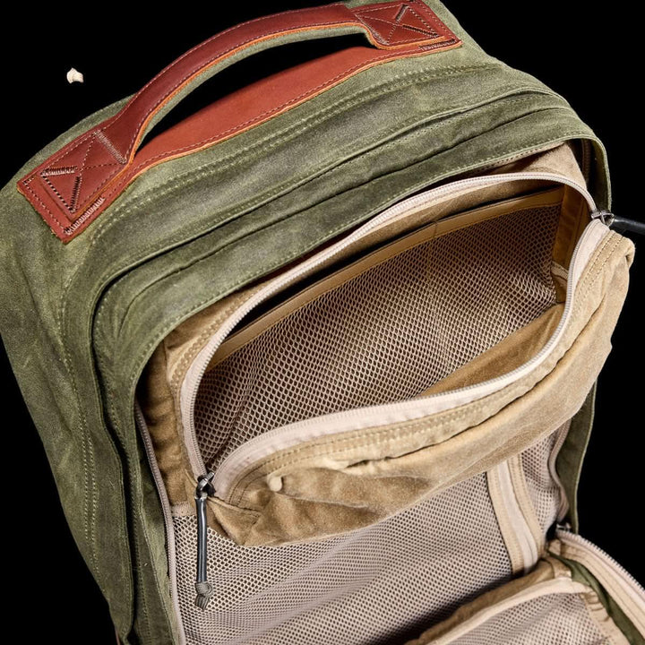 The GORUCK GR2 - Heritage Waxed Canvas backpack in olive green with a brown Red Wing Leather handle and mesh inner pockets, viewed from above—perfect as your next adventure rucksack.
