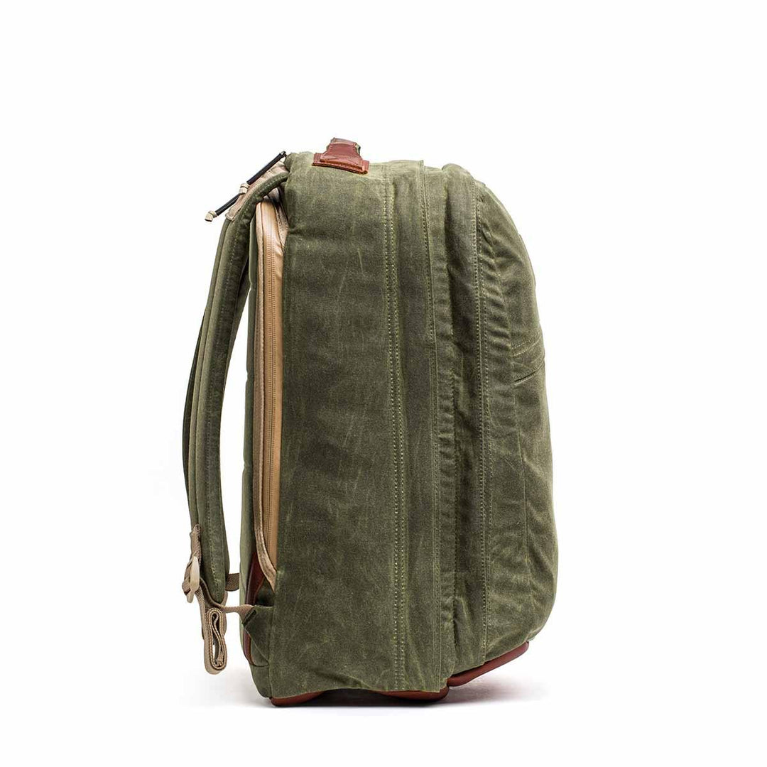 Side view of the GORUCK GR2 - Heritage Waxed Canvas backpack in green with brown leather accents and a visible zipper, perfect as a stylish travel rucksack.
