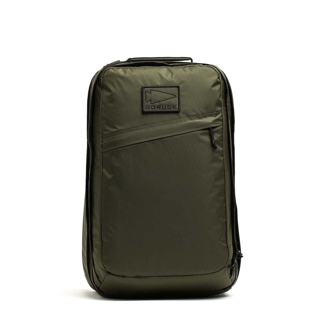 The olive green GORUCK GR2 X-PAC backpack features a front zipper pocket and stands upright against a white background—an ultra-durable, anything-proof ruck by GORUCK.