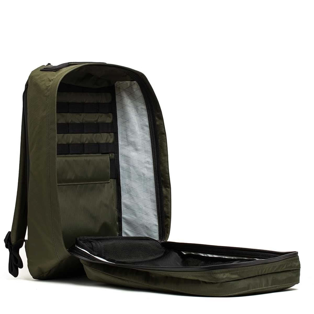 The GORUCK GR2 X-PAC backpack in olive green is open, displaying its organized interior pockets and compartments—a stylish, waterproof choice for any adventure.