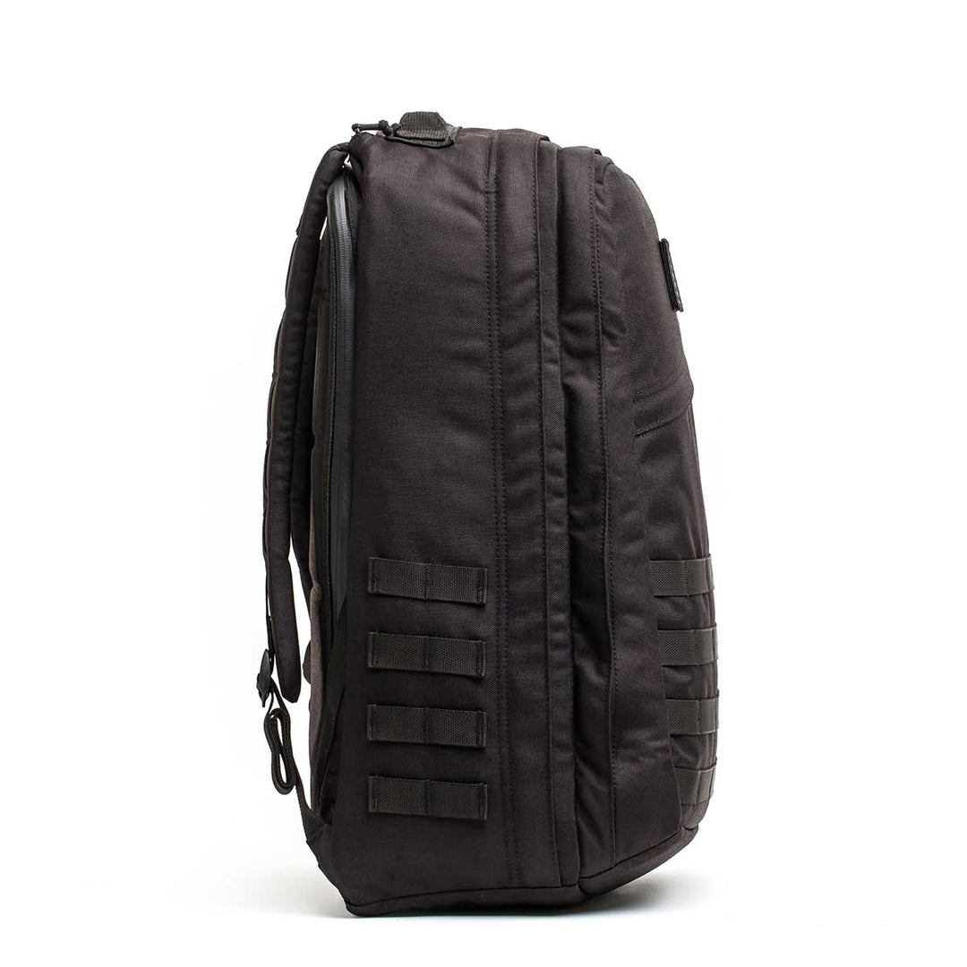 The GORUCK GR2 - USA tactical backpack stands upright in a side view, showing multiple straps and compartments—perfect as a Special Forces pack or carry-on travel bag for your next adventure.
