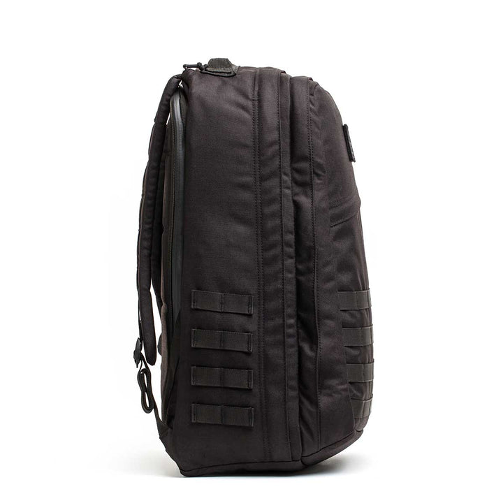 The GORUCK GR2 - USA tactical backpack stands upright in a side view, showing multiple straps and compartments—perfect as a Special Forces pack or carry-on travel bag for your next adventure.