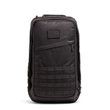 The black GR2 - Cordura ruck features a patch and several horizontal webbing straps on the front, stands upright, and is perfect as a carry-on travel bag.