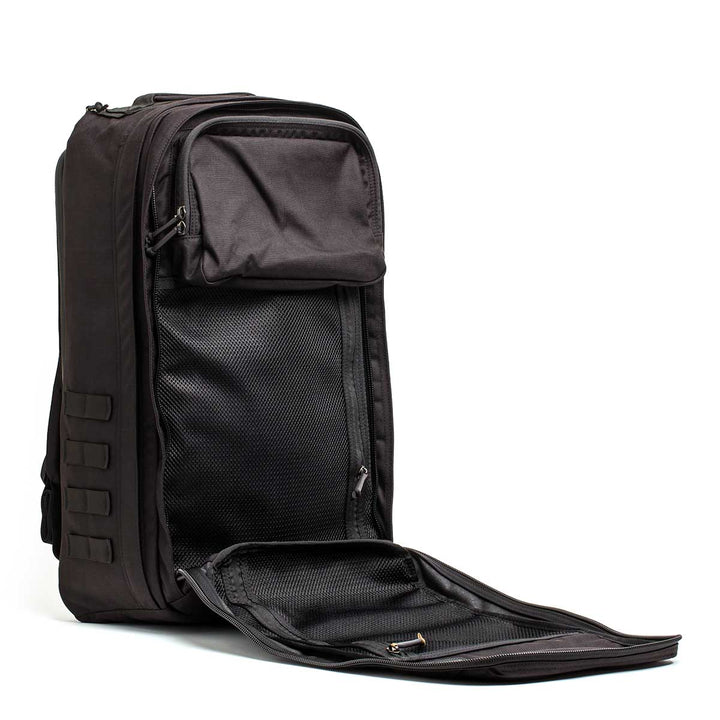 The black GORUCK GR2 - USA ruck stands upright with its front compartment unzipped, showing a mesh pocket inside—designed as the ultimate Special Forces backpack for all your carry-on travel bag needs.