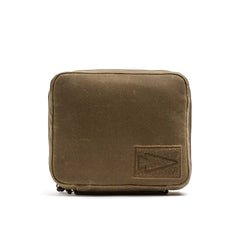 The GORUCK GR2 Field Pocket – Waxed Canvas is an olive green square pouch featuring a stitched arrowhead logo patch on the lower right corner, crafted in the style of a classic waxed canvas field pocket.