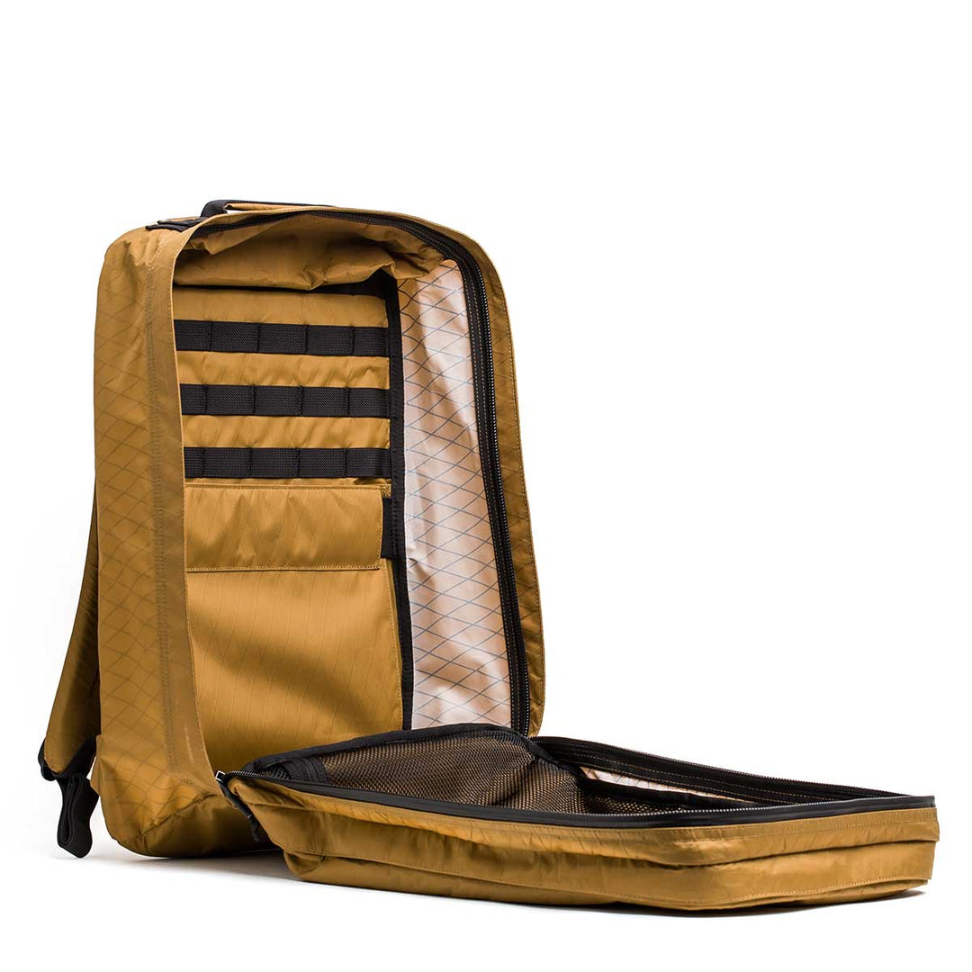 The GORUCK GR2 X-PAC travel backpack stands upright, displaying its organized interior pockets and compartments in this durable, anything-proof ruck.
