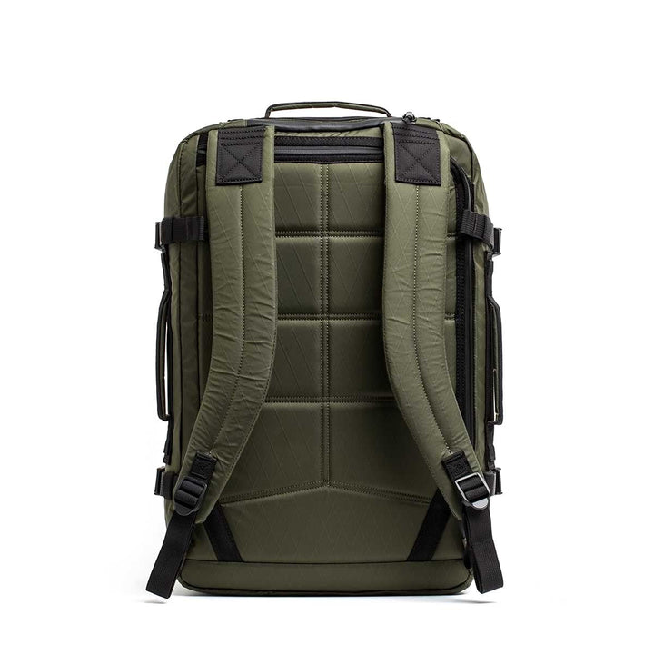 The GR3 - X-PAC carry-on backpack is shown from the back, featuring an olive green design with padded shoulder straps, a top handle, and a dedicated laptop compartment.