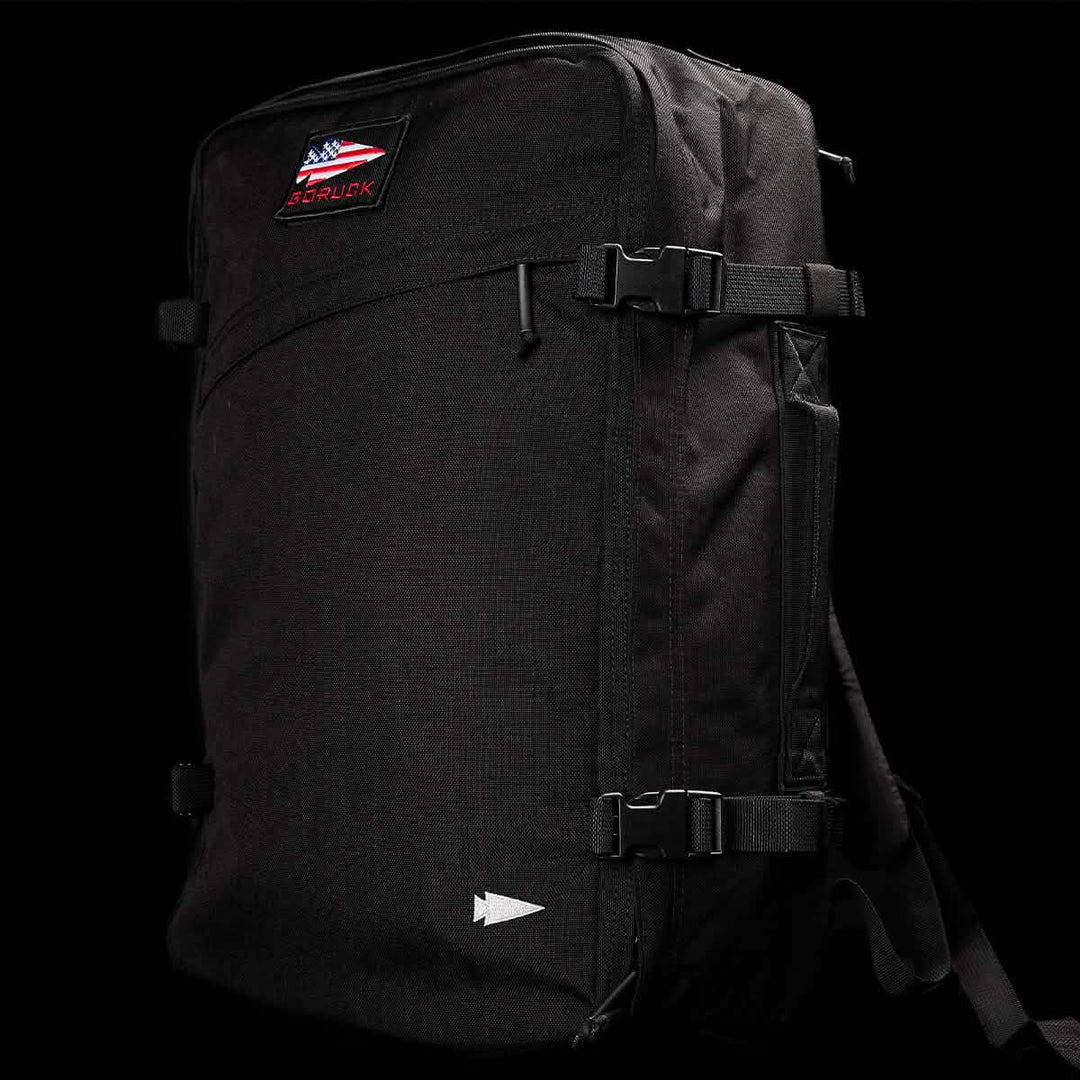 The GORUCK GR3 - Cordura is a black carry-on rucksack with buckle straps, waterproof zippers, and an American flag patch, shown against a black background.