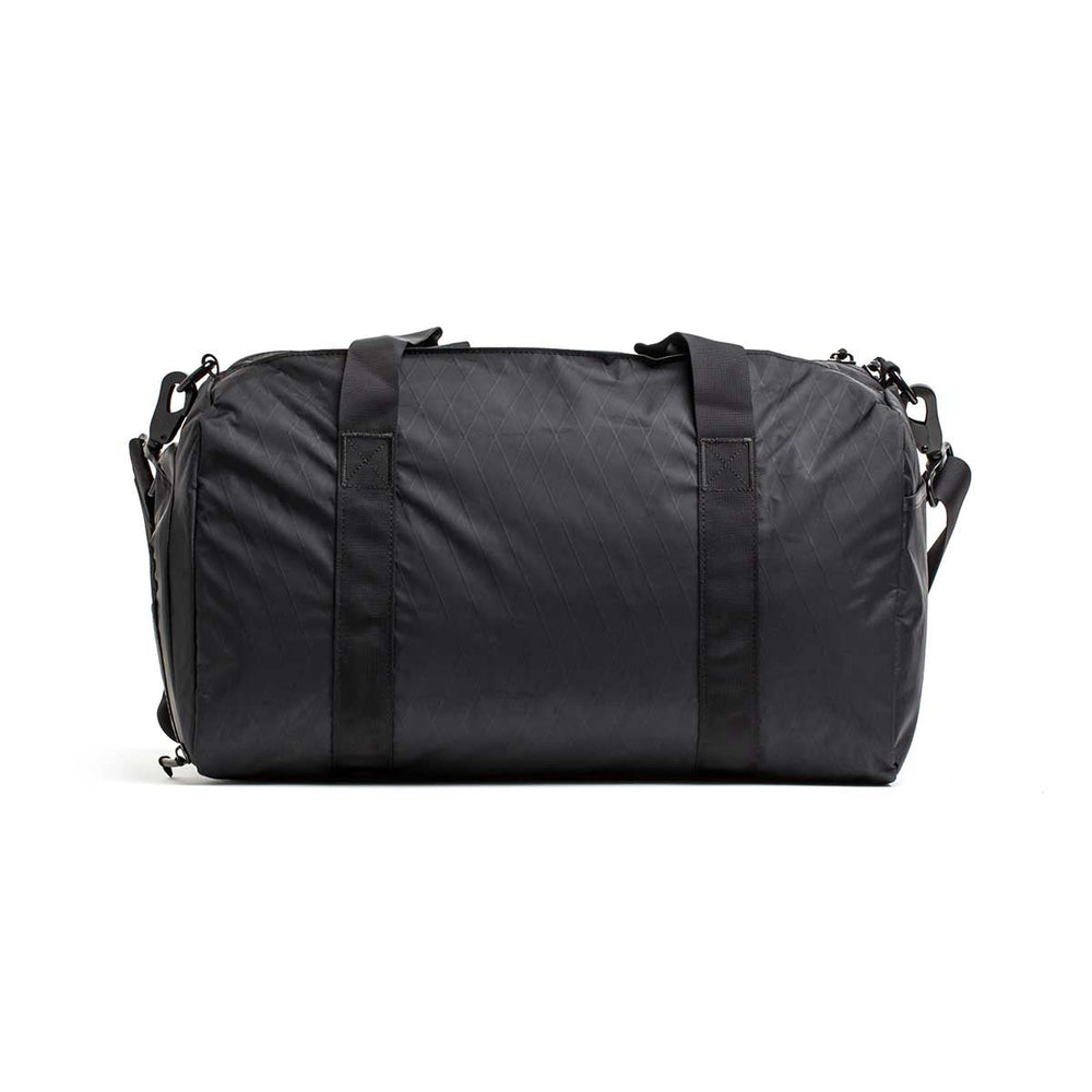The Gym Bag - X-PAC in classic black features two handles and a shoulder strap, shown against a white background.