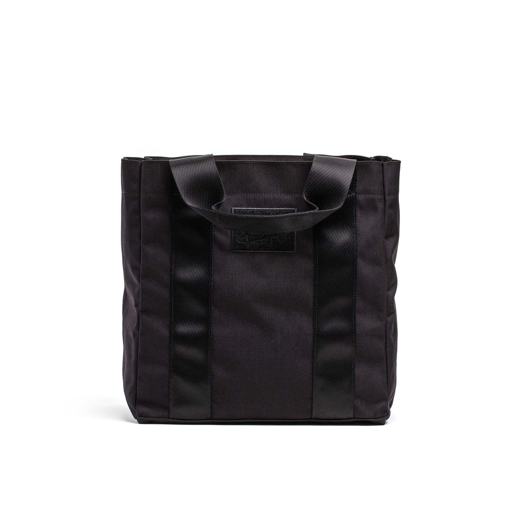 GORUCK black tactical tote bag with sturdy handles, durable rucking gear on white background