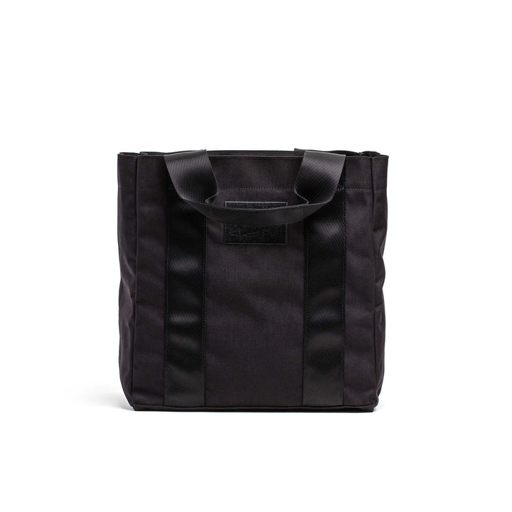 GORUCK black tactical tote bag with sturdy handles, durable rucking gear on white background