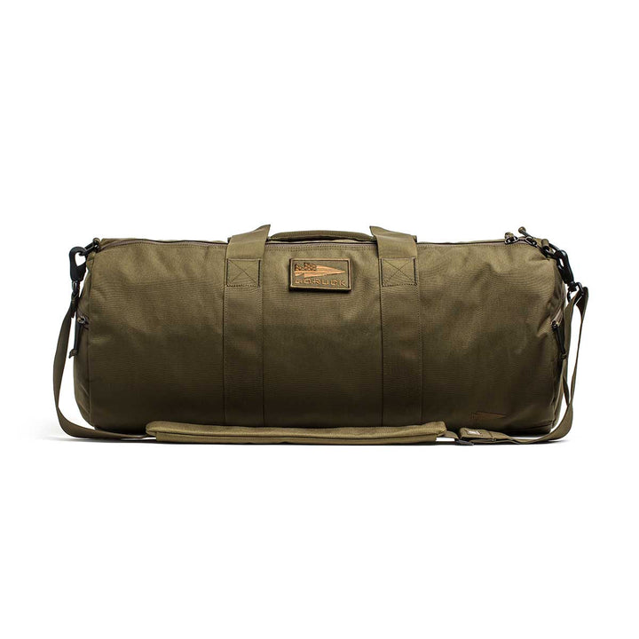 The Gym Bag - Cordura features olive green 1000D CORDURA fabric, sturdy handles, a shoulder strap, and a rectangular front patch.
