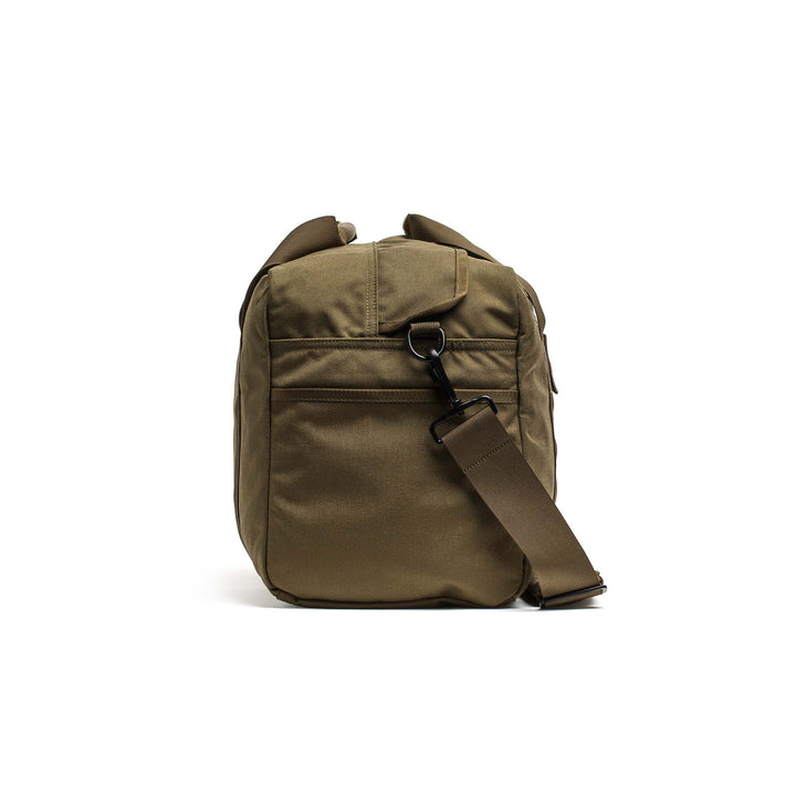 The GORUCK Kit Bag in olive green features a front pocket and adjustable strap, displayed from the front against a white background.