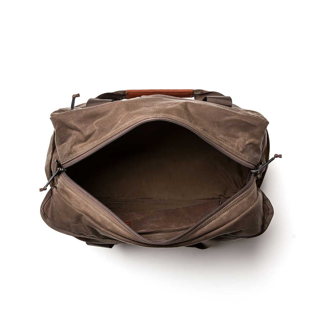 The GORUCK Kit Bag - Waxed Canvas is shown with its open zipper revealing a spacious, empty interior—ideal as a travel or aviator’s bag—displayed against a white background.