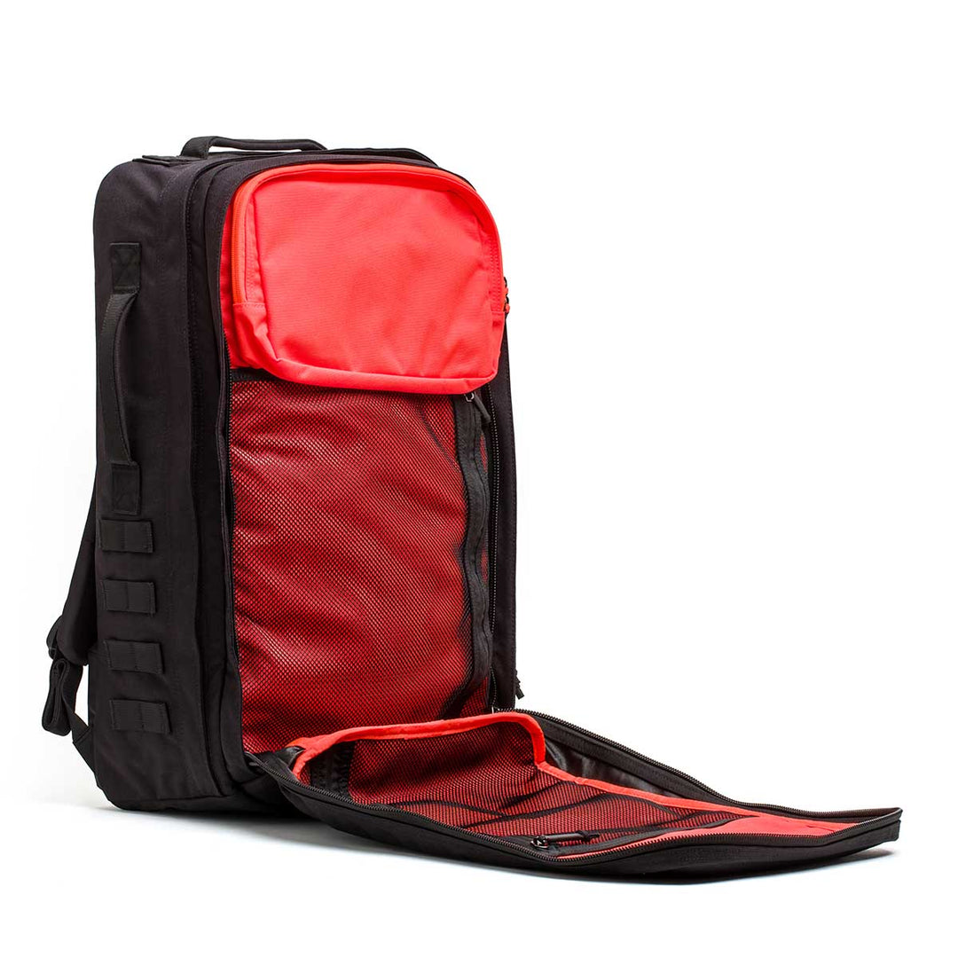 The Rucker - Long Range is a black backpack with a red interior, shown open to reveal multiple compartments and mesh pockets—ideal for comfortable distance rucking or tough rucking events.
