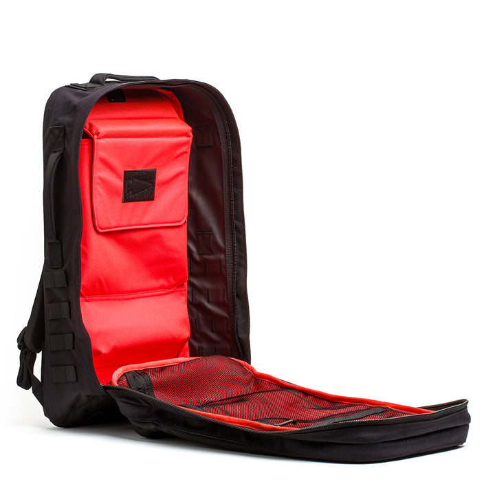 The Rucker - Long Range is a black backpack with a red interior, shown fully open to display its compartments and mesh pocket—perfect as a comfortable rucksack for rucking events or distance rucking.